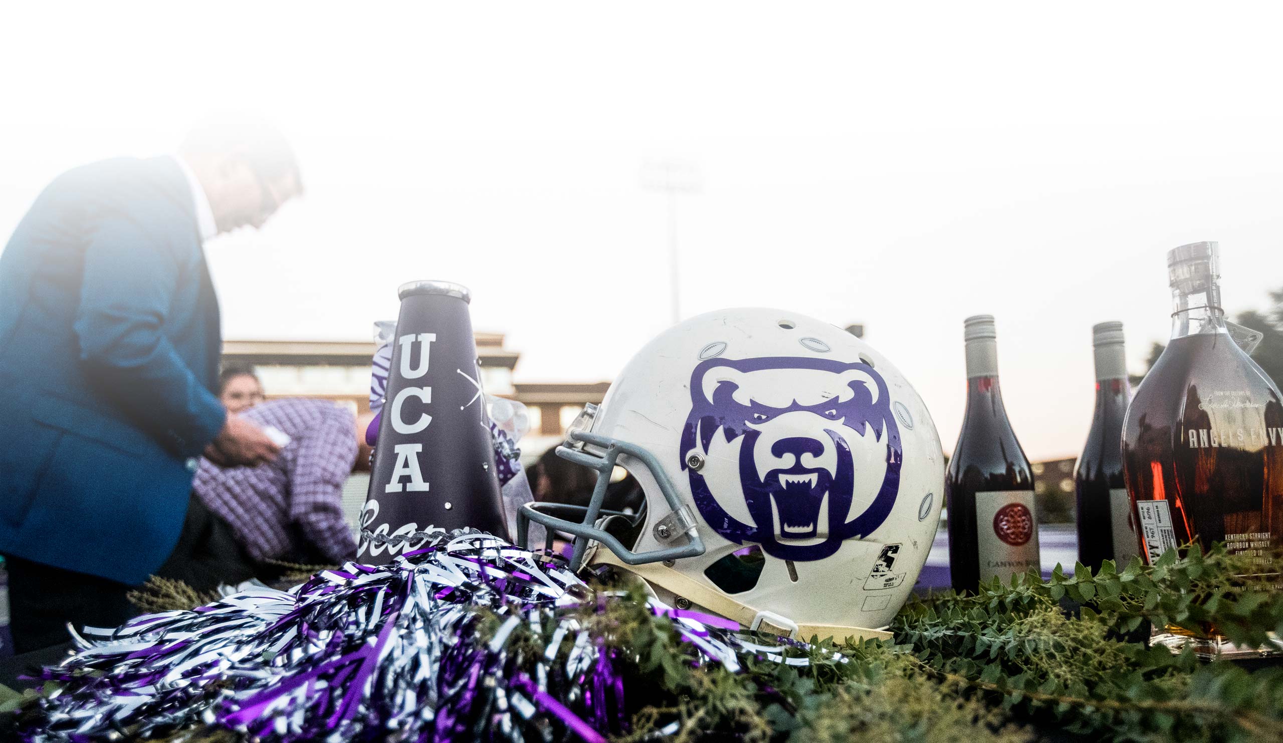 Donors getting food with a football helmet and bottles in forefront
