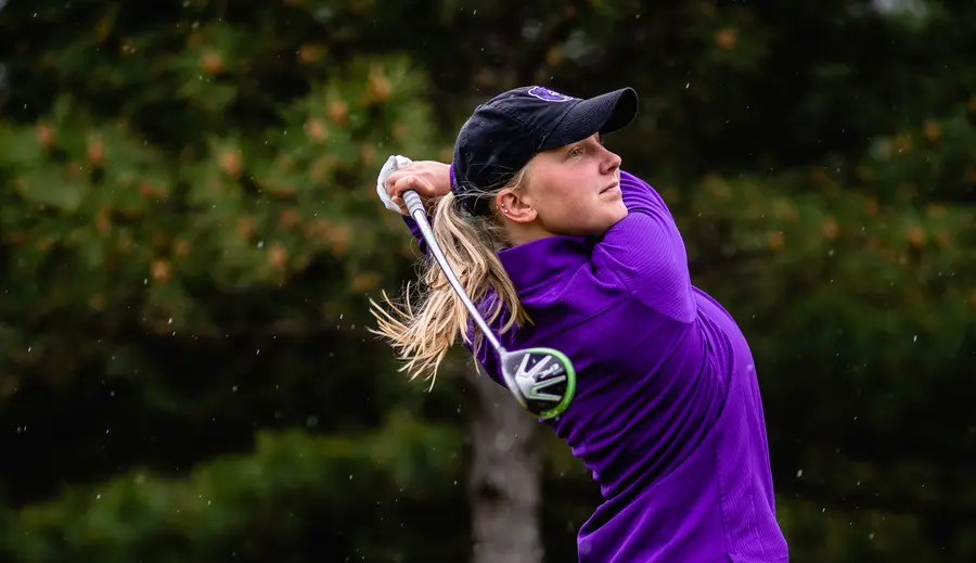 Women's golfer admiring her shot