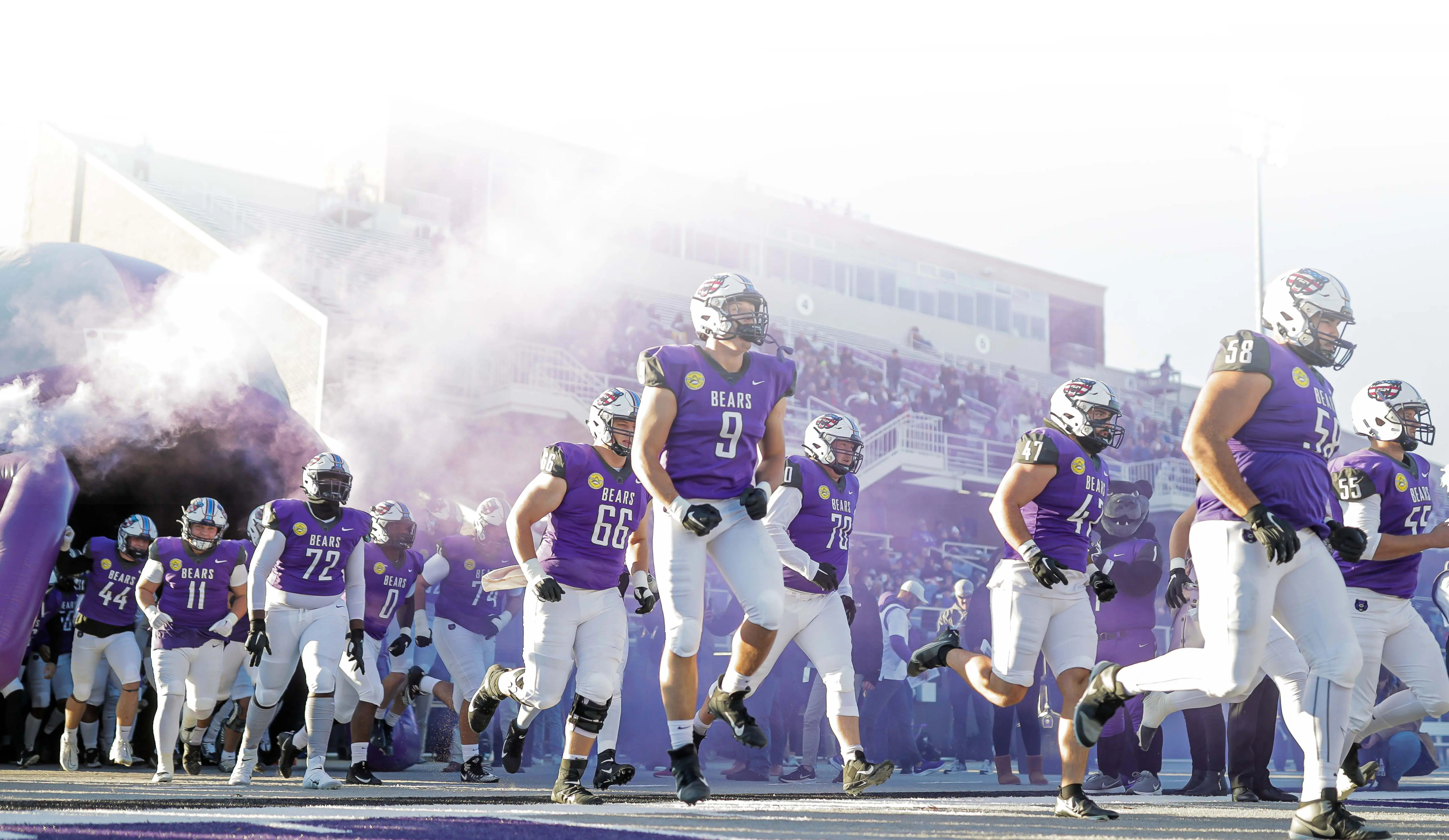 Football players running onto field