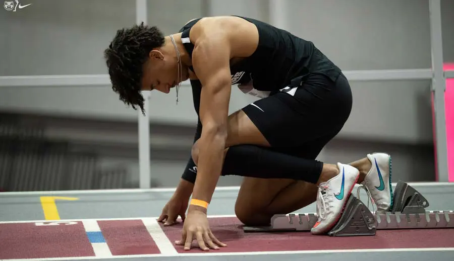 Track runner in starting stance