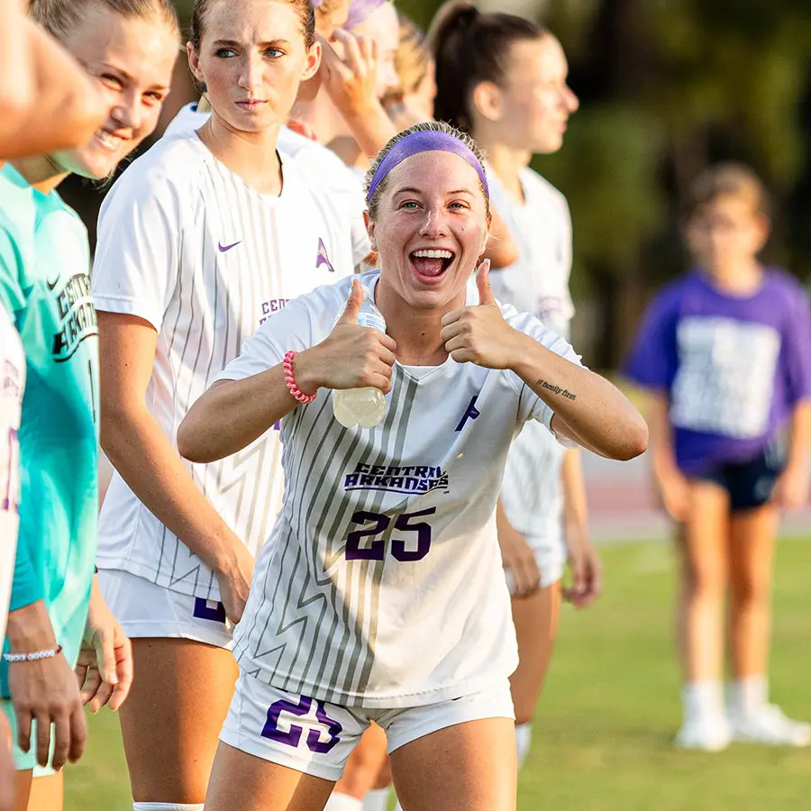 female soccer player giving two thumbs up
